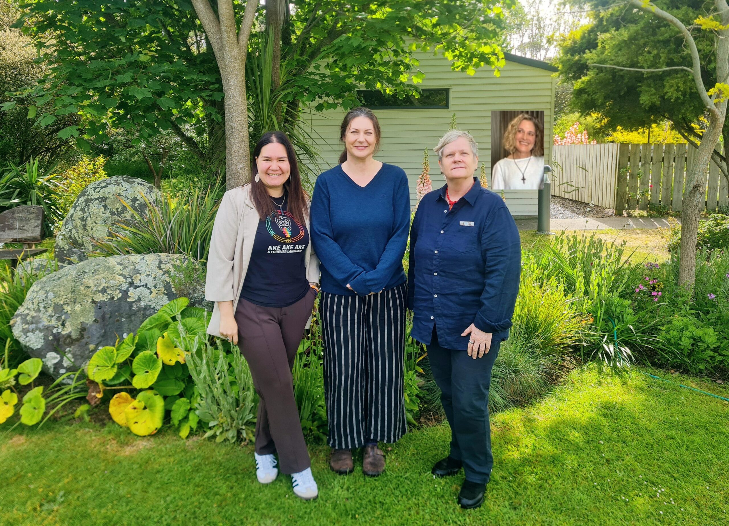 The Hospice Whanganui Whānau Support Team — Sam, Melissa, Carla, and Nelda (inset) — smiling together in the hospice gardens. The team stands among trees and greenery, representing the warmth, compassion, and collaboration they bring to supporting patients and their whānau.