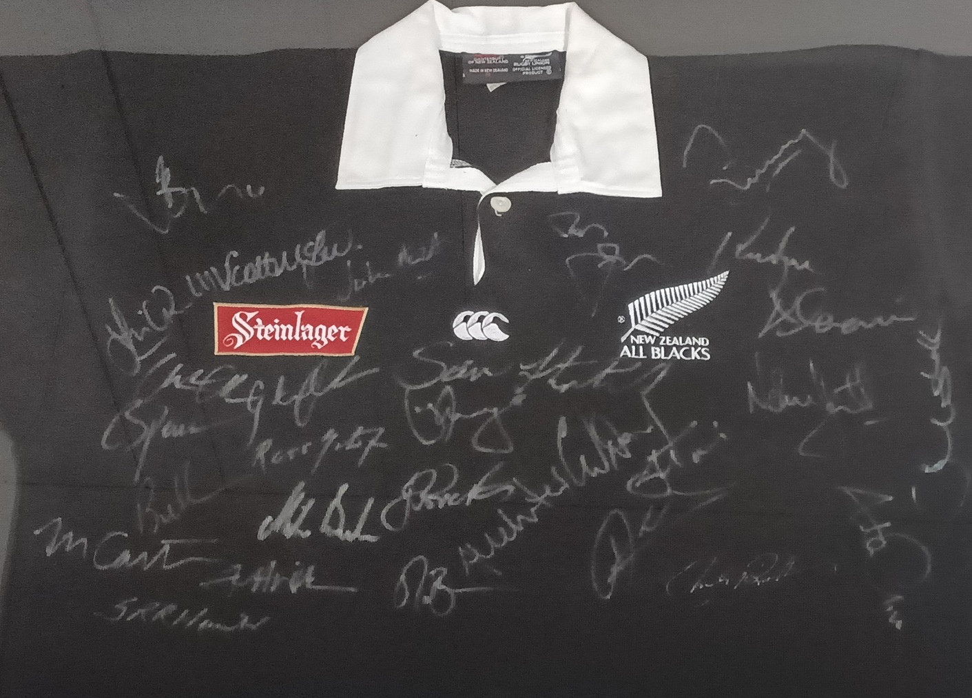 Close-up of signatures on a framed 1996 All Blacks jersey from the Incomparables South Africa tour